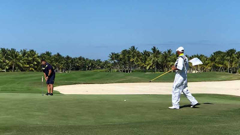 Golfer and Caddie at La Cana Punta Cana