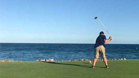 golfer teeeing off on 18 at Punta Espada Golf Course